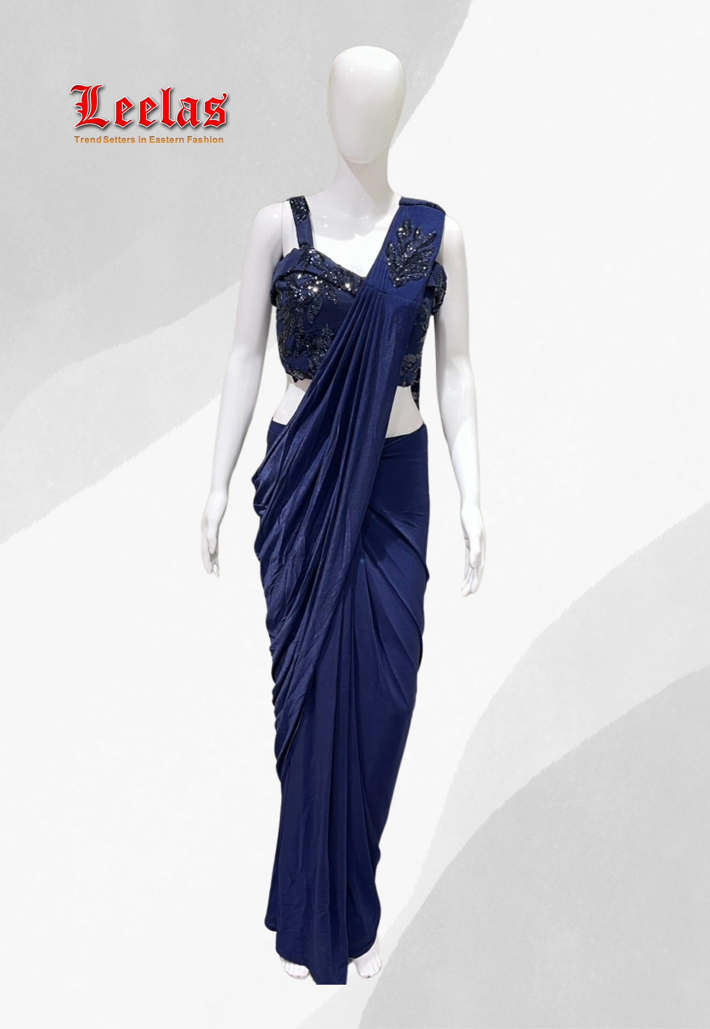 Navy blue silk ready stitched saree with net and sequin detail on sleeveless ready made blouse with unstitched sleeves